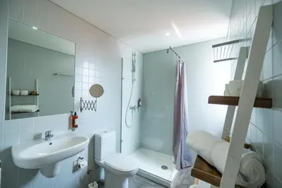 a bathroom with a sink and a toilet and a shower at Welcome Madeira Apartments by Wanderlust Madeira in Funchal