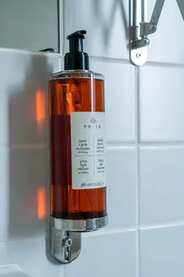 a bottle of soap is hanging on a wall at Welcome Madeira Apartments by Wanderlust Madeira in Funchal