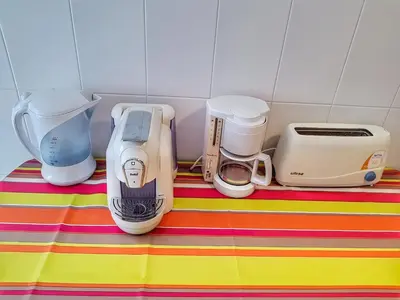 a group of appliances sitting on top of a table at Falesia Apartment - Reis Magos Beach in Caniço