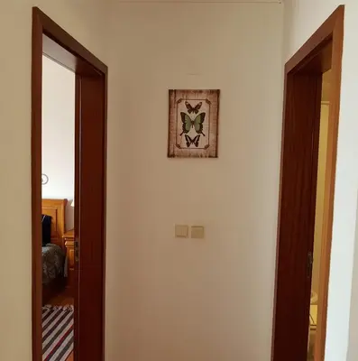 a room with a mirror and a picture on the wall at Falesia Apartment - Reis Magos Beach in Caniço
