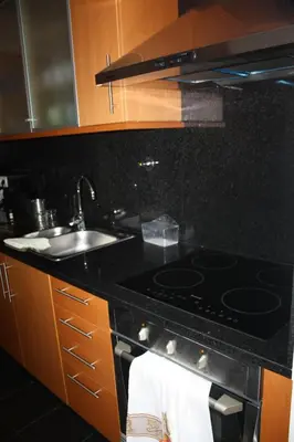 a kitchen with a stove and a sink at Holidays Plaza in Santa Cruz