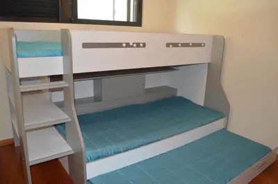 a bunk bed with a ladder in a room at Holidays Plaza in Santa Cruz