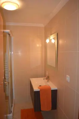 a bathroom with a sink and a mirror at Holidays Plaza in Santa Cruz