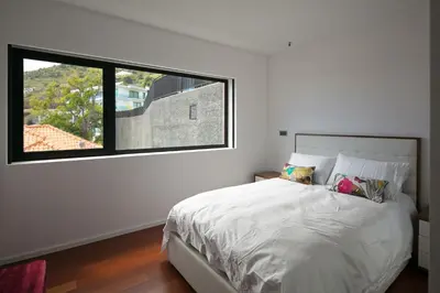 a bedroom with a bed with a large window at Spacious luxury holiday apartment with a great view, Funchal, free wifi and parking in Funchal