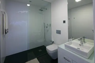 a bathroom with a toilet and a sink and a shower at Spacious luxury holiday apartment with a great view, Funchal, free wifi and parking in Funchal