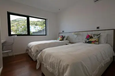 a bedroom with two beds and a window at Spacious luxury holiday apartment with a great view, Funchal, free wifi and parking in Funchal