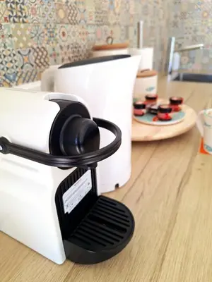 a toaster sitting on a counter next to a plate of cupcakes at Romantik Villa in Salema