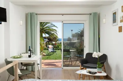 a living room with a door leading to a patio at Romantik Villa in Salema