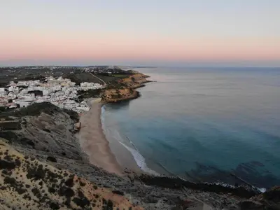 an aerial view of a beach and the ocean at Aloha Burgau Guesthouse in Burgau