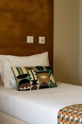 a bed with two pillows on top of it at Arrifana Destination Suites in Aljezur