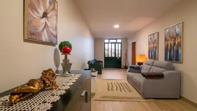 a living room with a couch and a table at Refugio do Sol - Madeira Inn Group in Calheta