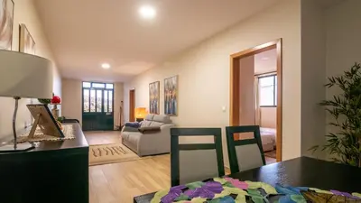 a living room with a table and a couch at Refugio do Sol - Madeira Inn Group in Calheta