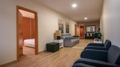 a living room with a couch and a bed at Refugio do Sol - Madeira Inn Group in Calheta