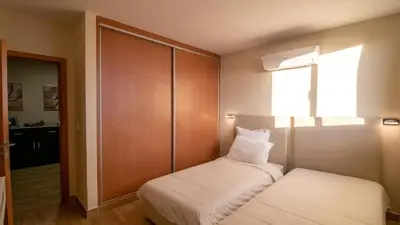 a small bedroom with a bed and a window at Refugio do Sol - Madeira Inn Group in Calheta