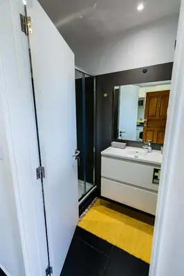 a bathroom with a sink and a mirror at Studio Oceano in Caniço