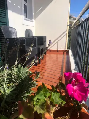 a balcony with pink flowers on a house at Em casa longe de casa, tão bom! in Gaula