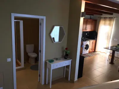 a kitchen with a toilet and a sink in a room at Villa Atlantis in Calheta