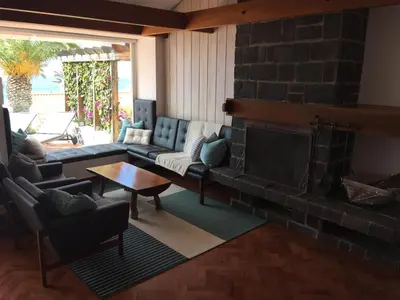 a living room with a couch and a fireplace at Casa Matschinegg Madeira in Caniço
