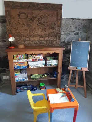 a classroom with a table and a chalkboard and a stool at Casa da Ribeira in São Vicente