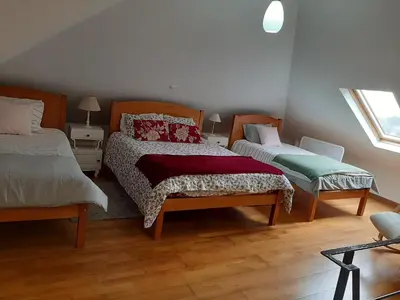 a bedroom with two beds and a window at Casa da Ribeira in São Vicente