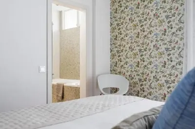 a bedroom with a white bed and a mirror at Casa Branca by Homie in Funchal