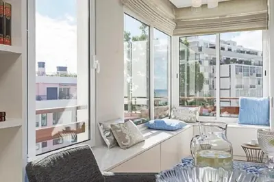a room with large windows and a table and chairs at Casa Branca by Homie in Funchal