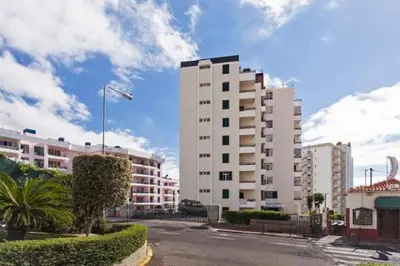 a large white building on a street with buildings at Casa Branca by Homie in Funchal