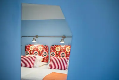 a bedroom with red and blue walls and a bed with pillows at Pestana Casino Studios in Funchal