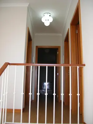 a room with a staircase with a light at Vila Faia in Caniço