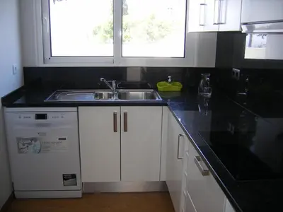 a kitchen with a sink and a dishwasher at Vila Faia in Caniço