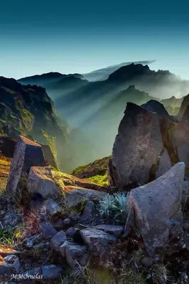a group of rocks on a mountain with fog in the background at Vila Faia in Caniço