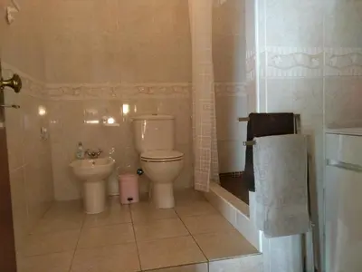 a bathroom with a toilet and a sink at Casa Alfarroba in Barão de São Miguel