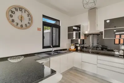 a kitchen with a large clock on the wall at Lazareto Apartment by Holiday Rental Madeira in Funchal