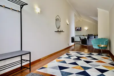 a living room with a blue chair and a rug at Paradise Ocean View by AnaLodges in Porto Moniz