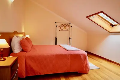 a bedroom with a red bed with a skylight at Paradise Ocean View by AnaLodges in Porto Moniz