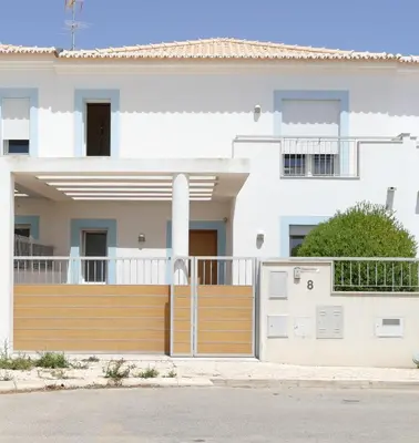 a house with a wooden fence and a garage at Your Villa Algarve Private pool 5 min walk to beach in Burgau