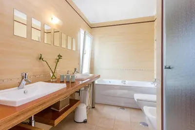 a bathroom with two sinks and a tub and a toilet at Your Villa Algarve Private pool 5 min walk to beach in Burgau