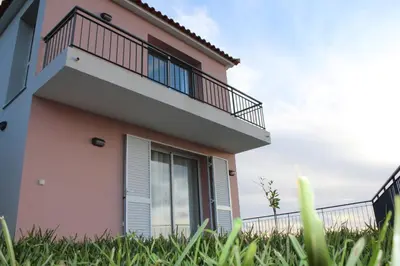 a house with a balcony and grass at Hills and Atlantic Ocean retreat - Conceição House in Calheta