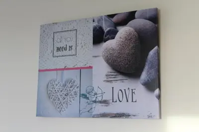 a book with a picture of a heart and some rocks at Hills and Atlantic Ocean retreat - Conceição House in Calheta