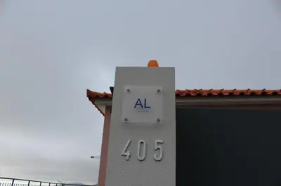 a clock on the side of a building at Hills and Atlantic Ocean retreat - Conceição House in Calheta