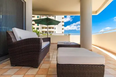 a large swimming pool in front of the ocean at OurMadeira - 6001 in Funchal
