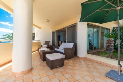 a living room with a dining room table and chairs at OurMadeira - 6001 in Funchal