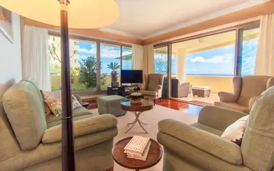 a living room with two couches and a television at OurMadeira - 6001 in Funchal