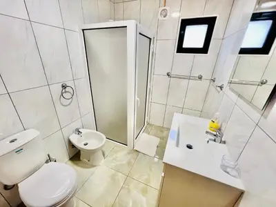 a bathroom with a toilet and a sink and a shower at Maria Cottage with Sea View in Estreito da Calheta