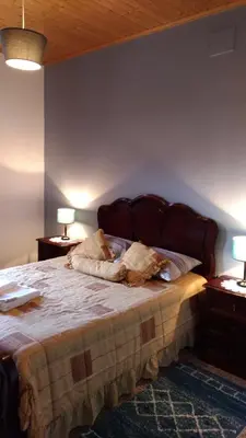 a bedroom with a bed with two dogs laying on it at Ape Esquerdo in São Vicente