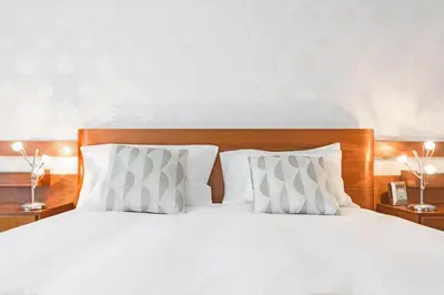 a bed with white sheets and pillows in a bedroom at Jasmineiro III by An Island Apart in Funchal
