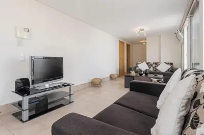 a living room with a couch and a tv at Jasmineiro III by An Island Apart in Funchal