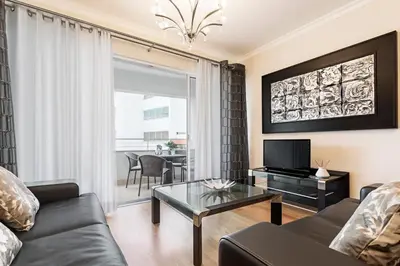 a living room with a couch and a glass table at Jasmineiro III by An Island Apart in Funchal