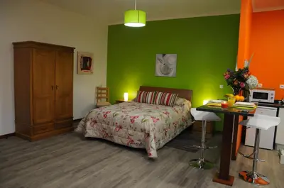 a bedroom with a bed and a green wall at Casa Nunes in Santana