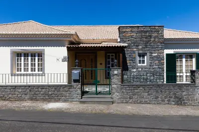 a house with a stone wall and a door at Casa Nunes in Santana